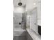 Walk-in shower with modern fixtures, rain shower head, built in bench and neutral colored tile at 219 Phillips Ln, Alpharetta, GA 30009