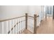 Upstairs hallway with white wood stair rail and light wood floors at 219 Phillips Ln, Alpharetta, GA 30009