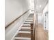 Staircase with wooden handrail and light hardwood floors, plus white trim at 219 Phillips Ln, Alpharetta, GA 30009