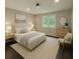 Stylishly staged bedroom with a neutral color palette, natural light, and hardwood floors at 2851 Headland Dr, East Point, GA 30344