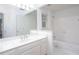 Bright bathroom with white cabinetry, tile flooring, and bath/shower combo at 5010 Bonnie Way, Roswell, GA 30075