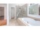 Bathroom with a walk-in shower, soaking tub, and tile floors at 5010 Bonnie Way, Roswell, GA 30075