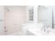 Well-lit bathroom featuring white cabinets, countertop and shower at 5010 Bonnie Way, Roswell, GA 30075