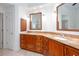 Bathroom featuring double sinks, a granite countertop, and wood cabinets at 5010 Bonnie Way, Roswell, GA 30075