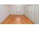 Bedroom with hardwood floors, white walls, and white built-in storage cabinets at 5010 Bonnie Way, Roswell, GA 30075