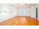 A spacious bedroom featuring hardwood floors, white walls, and a ceiling fan at 5010 Bonnie Way, Roswell, GA 30075