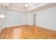 Bright bedroom with hardwood floors, a ceiling fan, and a window with white shutters at 5010 Bonnie Way, Roswell, GA 30075