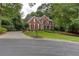 Lovely two-story brick home with a well-maintained lawn and mature trees at 5010 Bonnie Way, Roswell, GA 30075