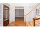 Bright foyer with hardwood floors, staircase, and view into built-in shelving at 5010 Bonnie Way, Roswell, GA 30075