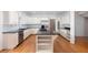 Spacious kitchen featuring white cabinets, stainless appliances, and central island at 5010 Bonnie Way, Roswell, GA 30075