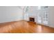 Spacious living area with hardwood floors, fireplace, and French doors at 5010 Bonnie Way, Roswell, GA 30075