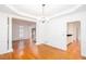 Open-concept living space with hardwood floors, white columns, and bright light at 5010 Bonnie Way, Roswell, GA 30075