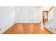Open living room with hardwood floors, shuttered windows, and classic trim at 5010 Bonnie Way, Roswell, GA 30075