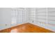 Well-lit office with hardwood floors, built-in shelves, and plantation shutters at 5010 Bonnie Way, Roswell, GA 30075
