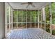 Screened porch with patterned tile flooring surrounded by a lush green landscape at 5010 Bonnie Way, Roswell, GA 30075