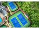 Aerial view of the community's blue tennis courts and well-maintained green landscaping at 5010 Bonnie Way, Roswell, GA 30075