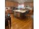 Expansive kitchen with a large island, wooden cabinets, and hardwood floors, perfect for culinary enthusiasts at 947 Simonton View Ln, Lawrenceville, GA 30045