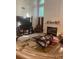 Sunlit living room boasting a fireplace, large windows, and comfortable seating, ideal for relaxation and entertainment at 947 Simonton View Ln, Lawrenceville, GA 30045
