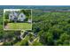 Aerial view shows the home's location in a tree-filled area, a sense of privacy and connection with nature at 103 Caracas Dr, Woodstock, GA 30188