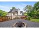 Landscaped backyard with firepit area and wooden fence is perfect for entertaining at 103 Caracas Dr, Woodstock, GA 30188