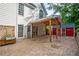 Backyard patio and storage shed with covered porch offer functional outdoor spaces at 103 Caracas Dr, Woodstock, GA 30188