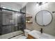 Modern bathroom with walk-in shower, decorative wallpaper, stylish fixtures, and natural light at 103 Caracas Dr, Woodstock, GA 30188