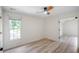 Bedroom with light hardwood flooring, ceiling fan and large windows at 103 Caracas Dr, Woodstock, GA 30188