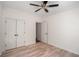 Bright bedroom features hardwood floors, ceiling fan, and closet space at 103 Caracas Dr, Woodstock, GA 30188