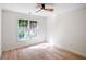 Bedroom with light hardwood flooring and window letting in natural light at 103 Caracas Dr, Woodstock, GA 30188
