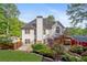 Rear exterior view of home and shed, surrounded by landscaping and greenery at 103 Caracas Dr, Woodstock, GA 30188