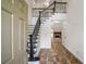 Grand foyer boasts hardwood floors, staircase with rod iron spindles and fireplace at 103 Caracas Dr, Woodstock, GA 30188