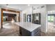 Bright kitchen with a central island, modern appliances, open shelving, and a view to the living room at 103 Caracas Dr, Woodstock, GA 30188