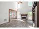 Bright living room with fireplace, hardwood floors, wooden beam, and connection to kitchen at 103 Caracas Dr, Woodstock, GA 30188