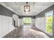 Bright living room with a coffered ceiling, wainscoting, hardwood floors, and large windows offering ample natural light at 103 Caracas Dr, Woodstock, GA 30188