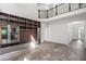 Spacious open-plan living room featuring hardwood flooring, a custom media center, and staircase to upper level at 103 Caracas Dr, Woodstock, GA 30188