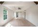 Bright main bedroom with hardwood floors, modern fan, tray ceiling, and an en suite bathroom at 103 Caracas Dr, Woodstock, GA 30188