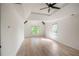 A spacious main bedroom with tray ceiling, wooden floors, natural lighting, and shiplap accent wall at 103 Caracas Dr, Woodstock, GA 30188