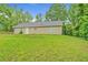 The backyard has a large grassy area, with views of mature trees at 126 Usher Ln, Covington, GA 30016