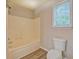 Bright bathroom with a shower-tub combo, and a large window for natural light at 126 Usher Ln, Covington, GA 30016