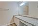 Well-maintained bathroom with a white vanity, granite countertops, and a large mirror at 126 Usher Ln, Covington, GA 30016