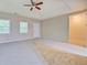 Bedroom showcasing a ceiling fan, tray ceiling, carpet, and windows offering natural light at 126 Usher Ln, Covington, GA 30016