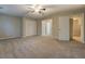 A spacious, bright bedroom with carpeting, a ceiling fan, and closet space at 126 Usher Ln, Covington, GA 30016