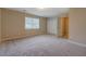 Bedroom featuring neutral walls, plush carpeting, natural light from a window, and a closet at 126 Usher Ln, Covington, GA 30016