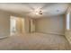Large bedroom with a ceiling fan, plush carpet, and easy access to the bathroom at 126 Usher Ln, Covington, GA 30016