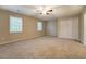 Spacious carpeted bedroom featuring neutral colors, ceiling fan, and large closet at 126 Usher Ln, Covington, GA 30016