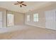 Bright bedroom with carpet flooring, tray ceiling, and a private en-suite bathroom at 126 Usher Ln, Covington, GA 30016