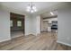 Dining area featuring light-colored wood flooring, a chandelier, and a view of the kitchen at 126 Usher Ln, Covington, GA 30016