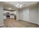 Dining area featuring wood flooring, chandelier, and view of the kitchen with stainless steel appliances at 126 Usher Ln, Covington, GA 30016
