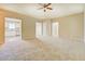 Spacious living room featuring neutral walls, carpet flooring, and a view of the adjacent kitchen at 126 Usher Ln, Covington, GA 30016