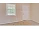 Bright room with carpet, a window letting in natural light, and a white door providing access at 126 Usher Ln, Covington, GA 30016